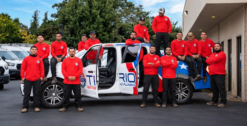 Team of HVAC professionals in red shirts posing with a branded truck outside, ready to serve clients.