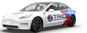 A white car with "TRIO Heating & Plumbing" branding and logo, featuring a red, blue, and white star design on the rear side, highlights their expert heating and air conditioning services.