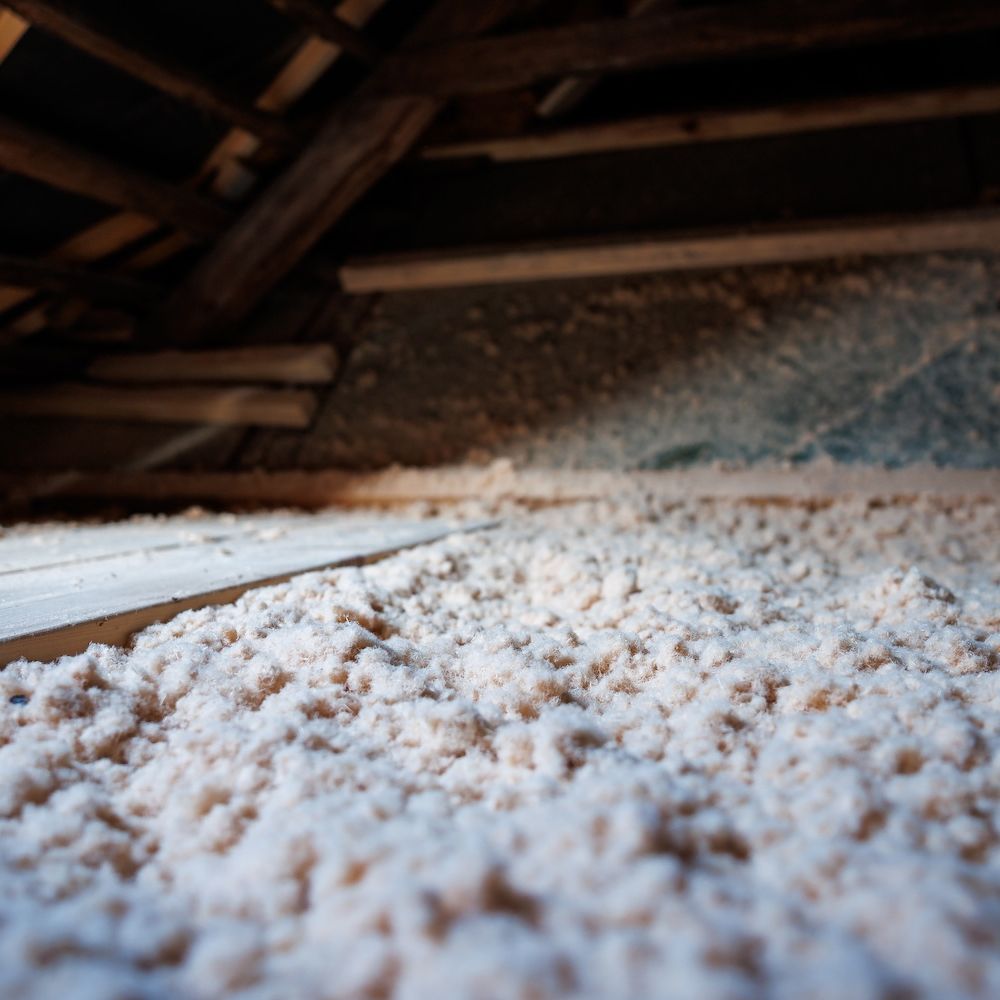 Insulated attic with cellulose fiber for energy efficiency and improved home comfort.